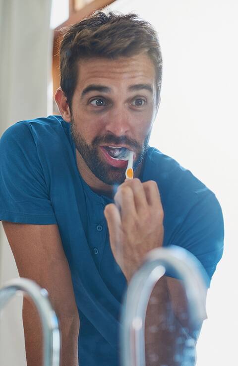man using colgate toothbrush